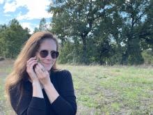 Tana Silverland listening to an acorn